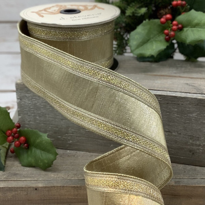 d. stevens 2.5 inch gold metallic faux dupioni wired ribbon with shimmering metallic stripe edges displayed on a spool, perfect for structured bows, wreaths, Christmas trees, floral arrangements and luxury décor.