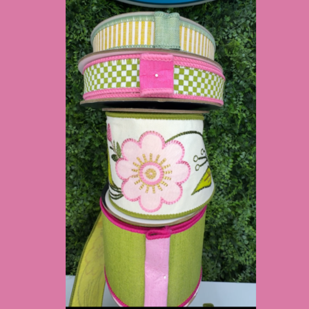 Spool of Farrisilk green and pink ribbon with floral design with three corrdinating ribbons against a pink and green background