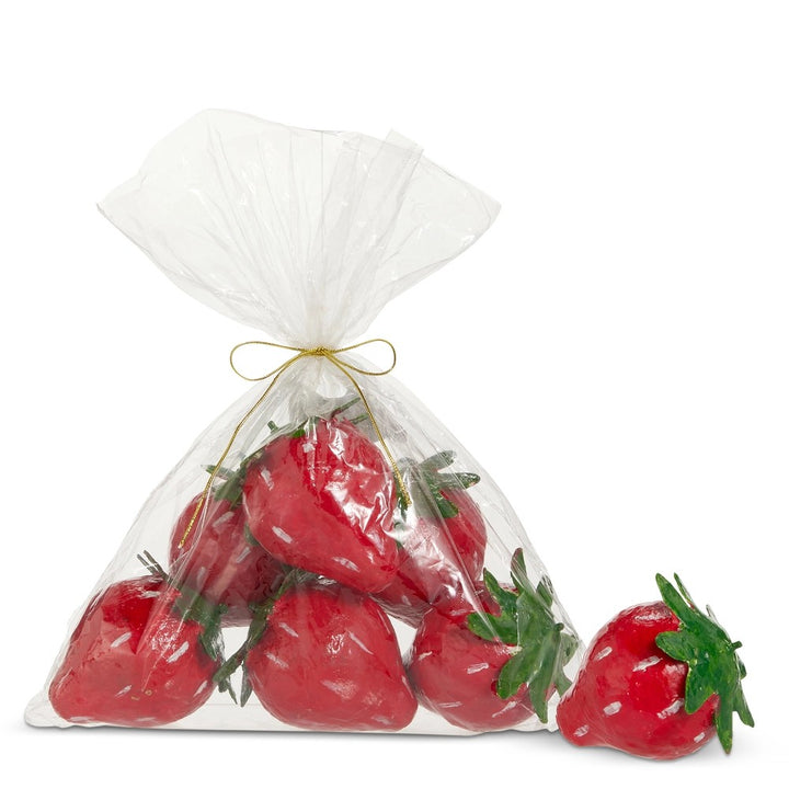 Bag of red strawberries with green stems on a white background