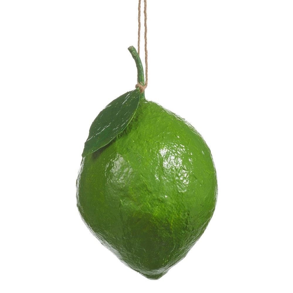 Green lime hanging from a string on a white background