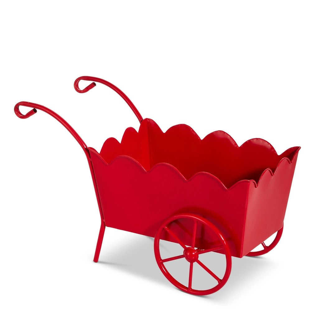 Red metal wheelbarrow planter on a white background