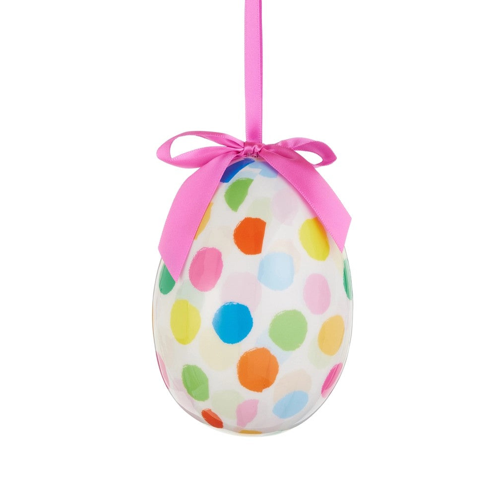 Decorative Easter egg with colorful polka dots and a pink ribbon on a white background