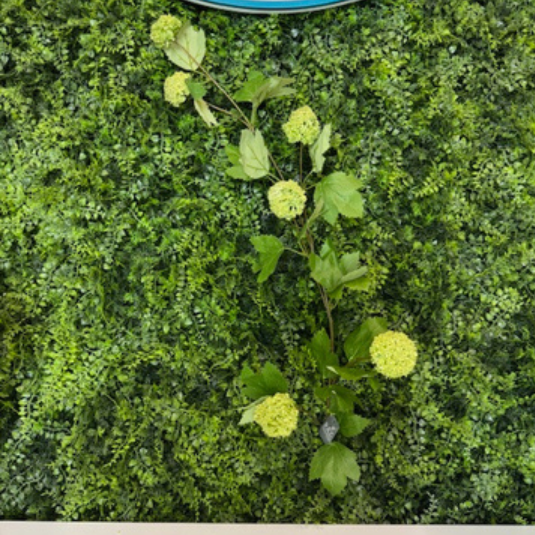 Artificial green bush with green flowers on a green background