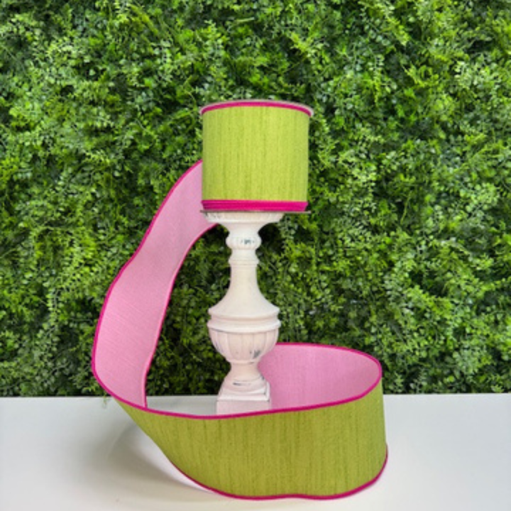 Farrisilk green ribbon with pink back against a green leafy background