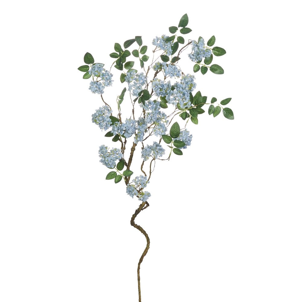 Artificial flower branch with blue flowers and green leaves on a white background