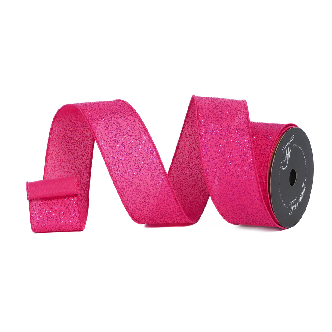 Pink glitter ribbon on a spool with a white background