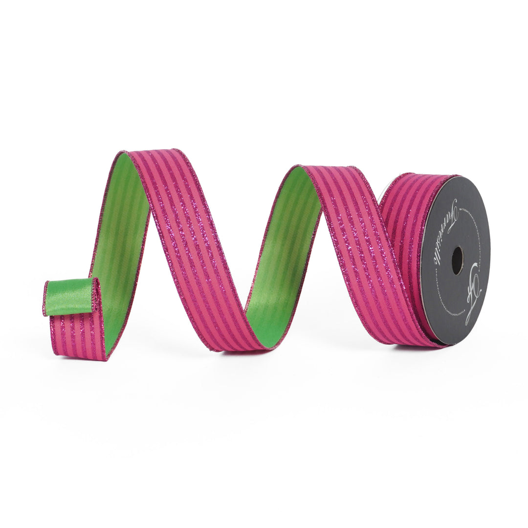 Pink and green ribbon on a spool with a white background