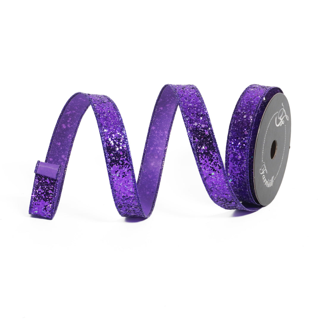 Spool of purple glitter ribbon on a white background