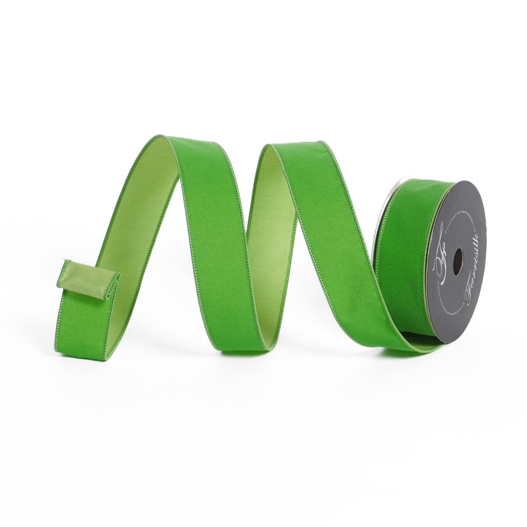 Green ribbon with a spool on a white background