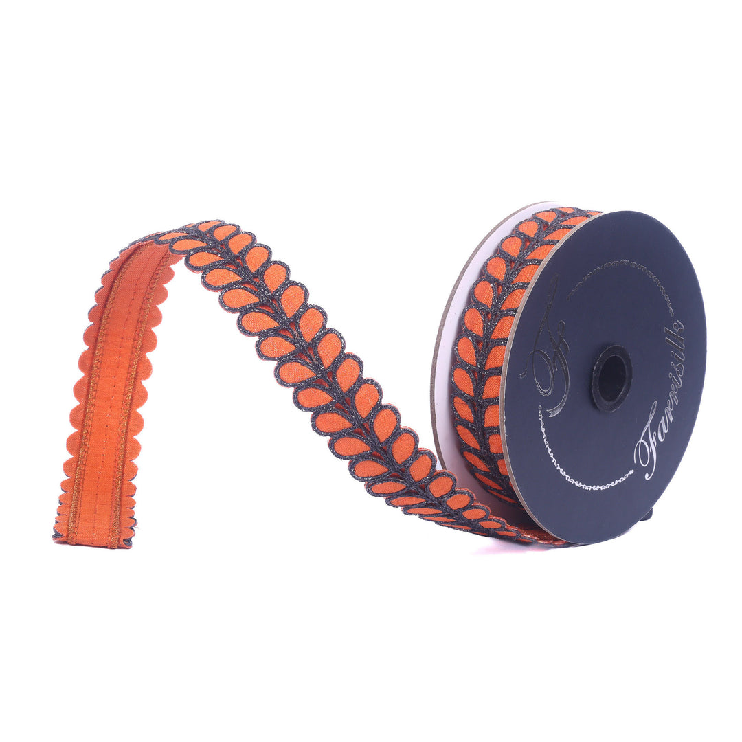 Spool of orange and black decorative ribbon on a white background