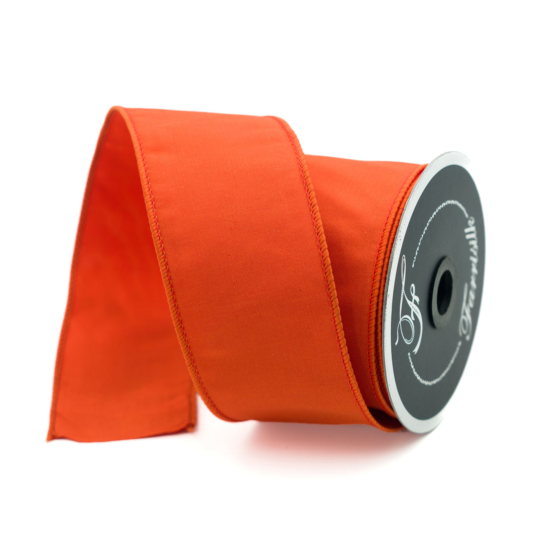 Spool of orange ribbon with a brand logo on a white background