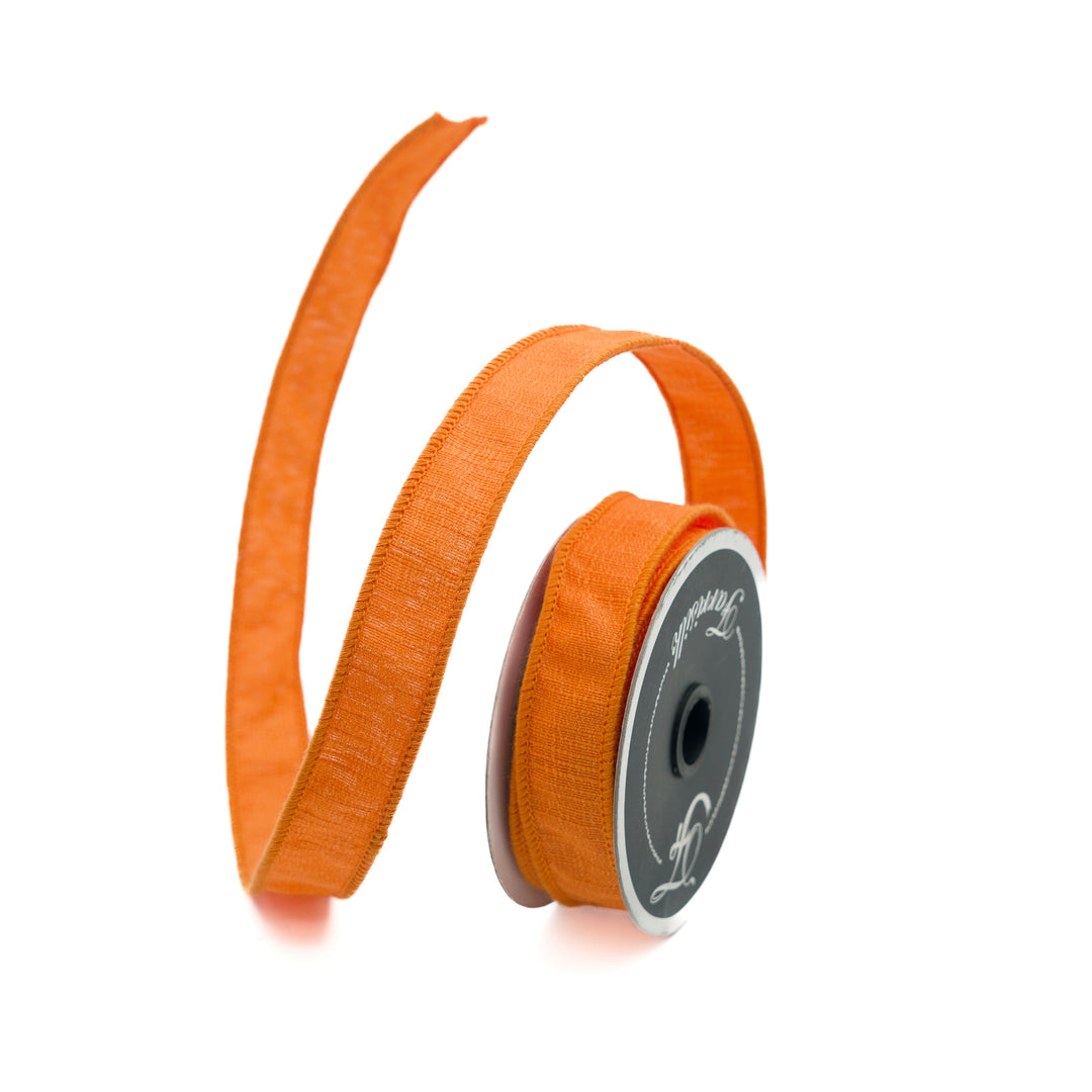Orange ribbon on a spool with a visible brand logo against a white background