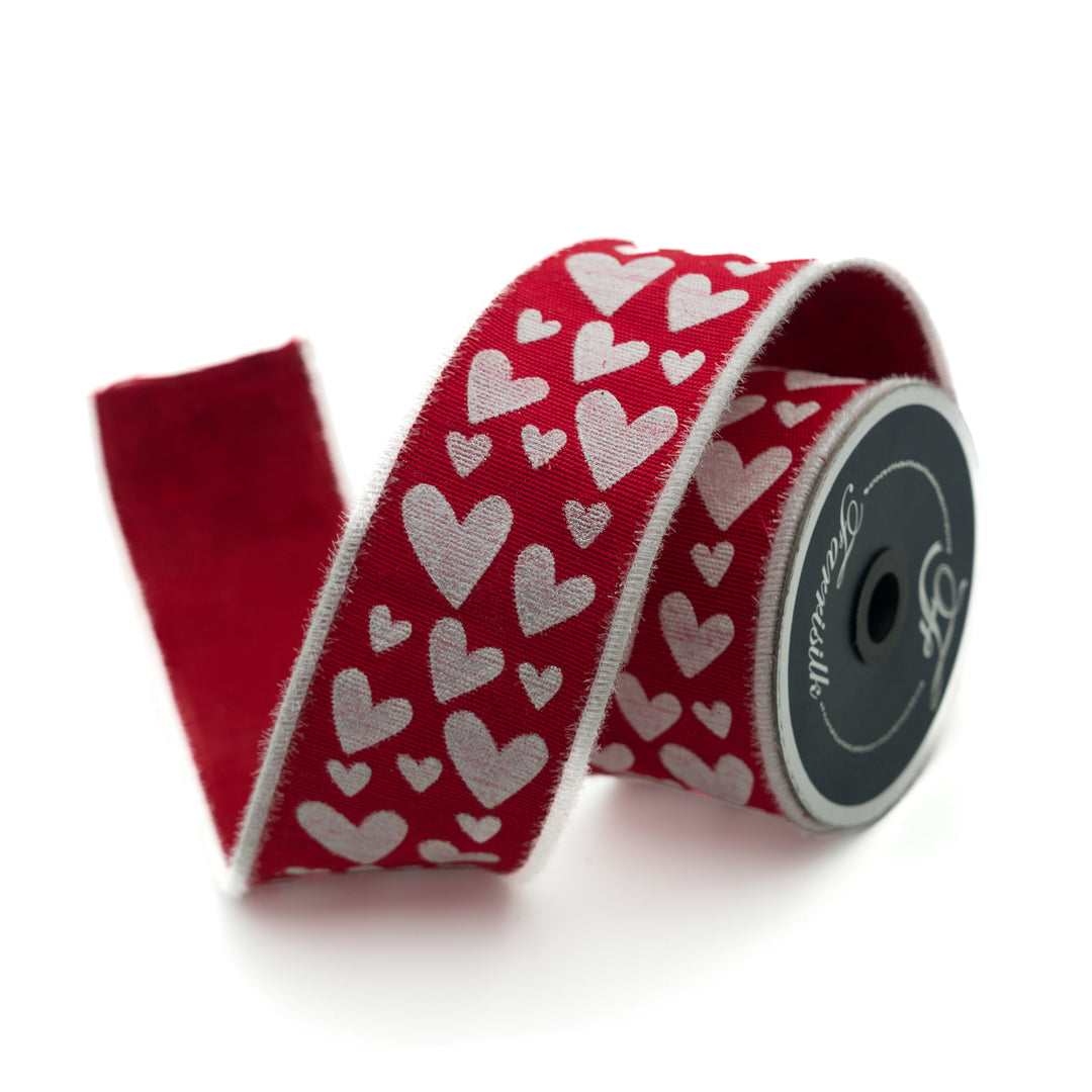 Red ribbon with white heart pattern on a white background