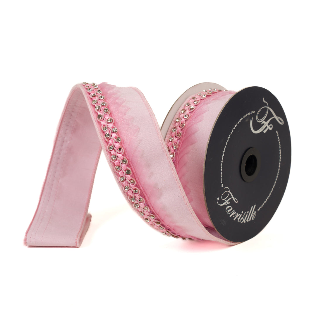 Pink ribbon with decorative crystals on a spool labeled 'Farrisilk' against a white background