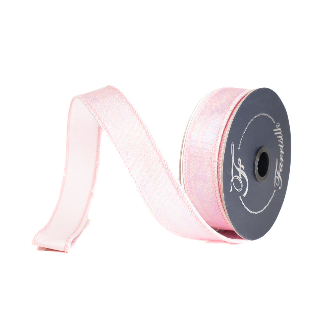 Roll of pink ribbon with a spool on a white background
