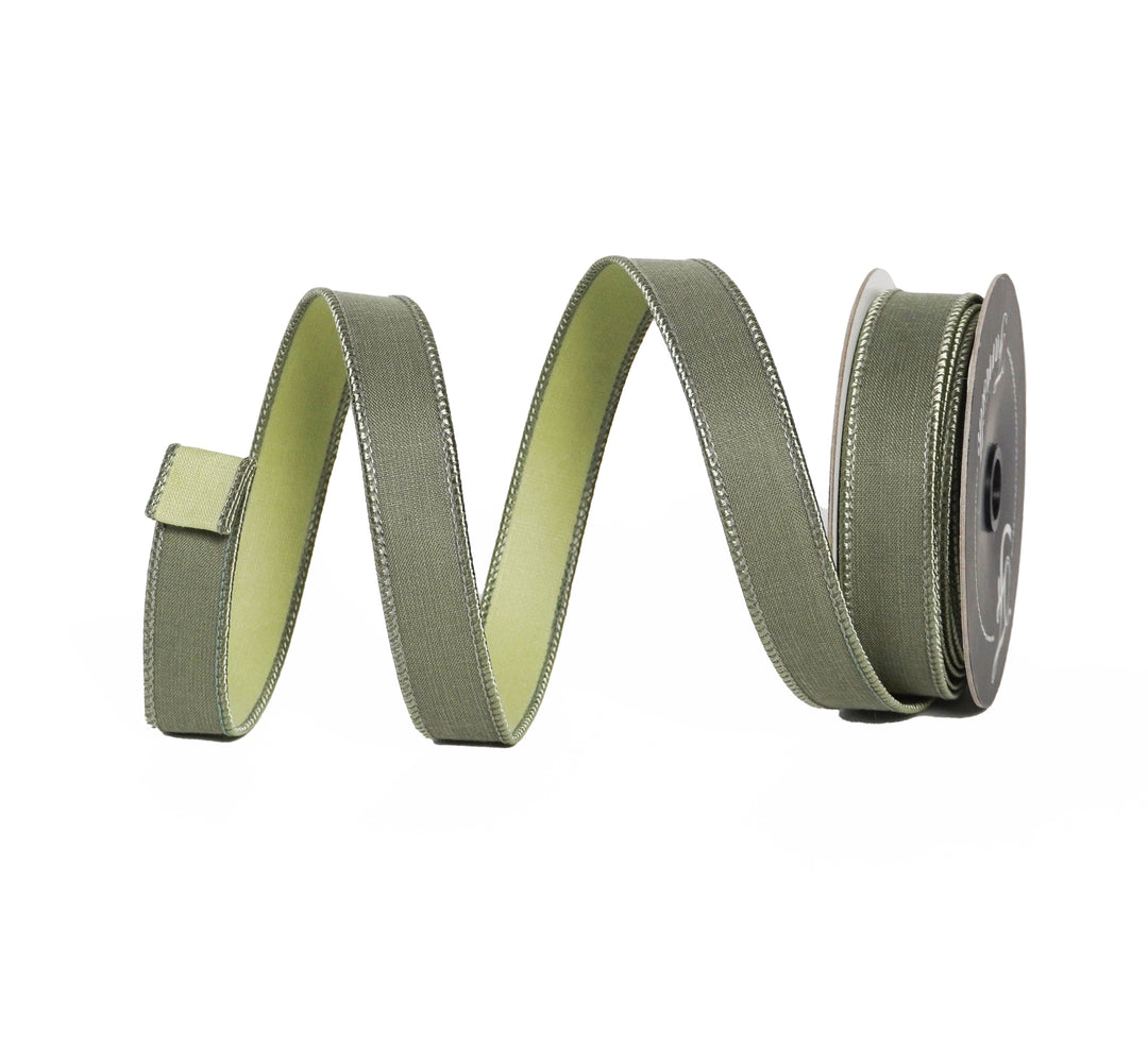 Green ribbon with a spool on a white background
