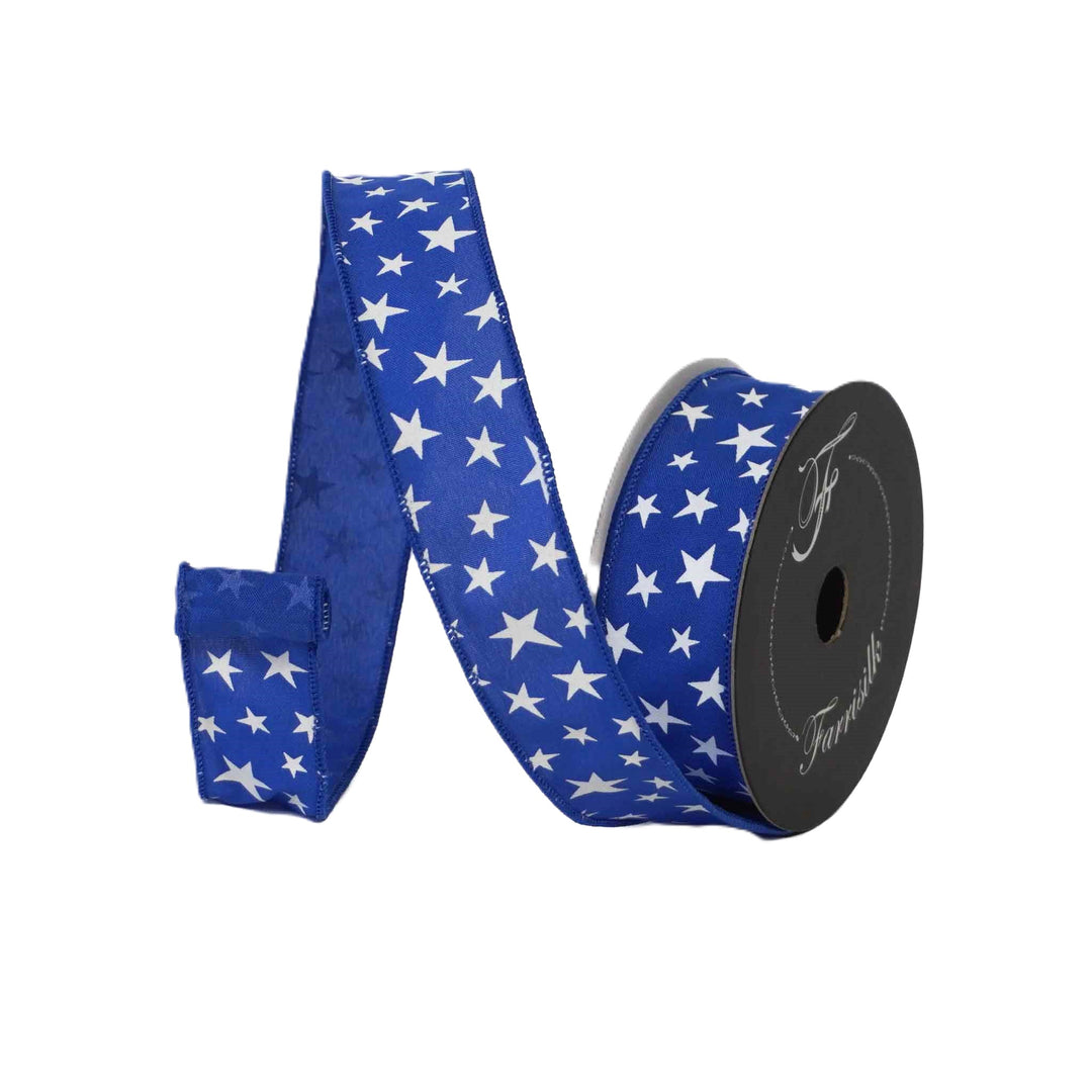 Blue ribbon with white star pattern on a spool against a white background