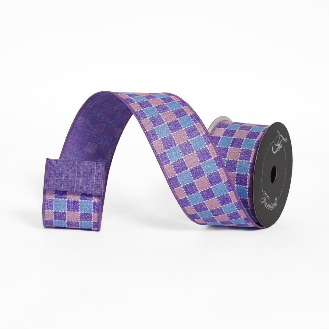 Roll of purple and pink checkered ribbon on a white background