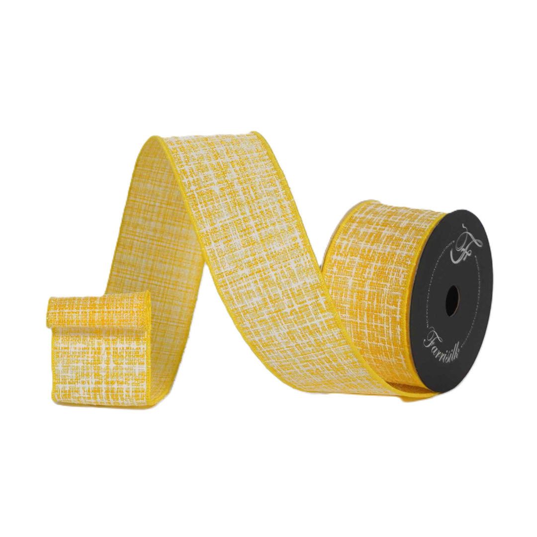 Yellow ribbon with white pattern on a spool against a white background