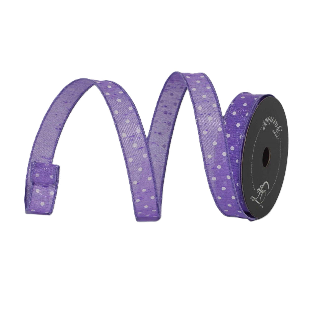 Spool of purple ribbon with white polka dots on a white background