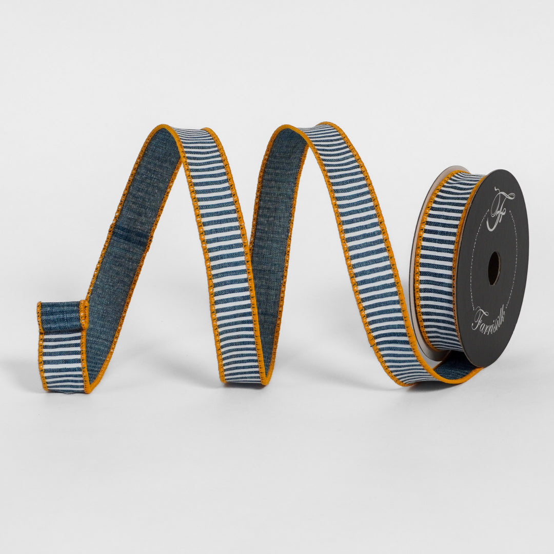 Striped ribbon with blue and white pattern on a spool against a light gray background