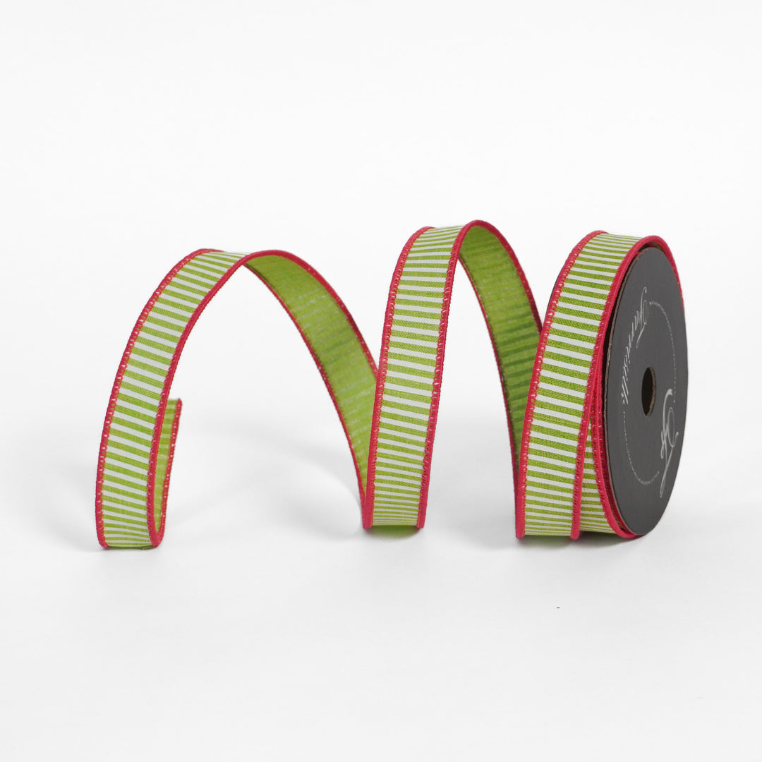 Green and red striped ribbon on a spool against a white background