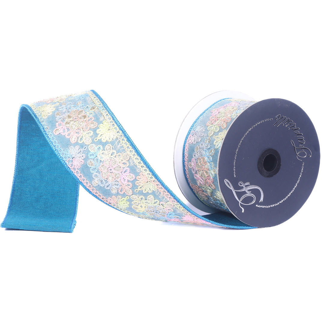 Roll of blue ribbon with floral pattern on a white background