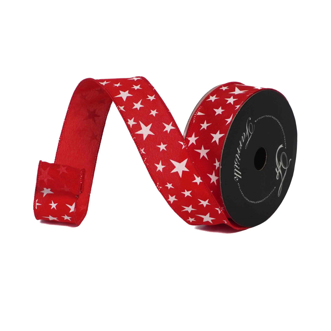 Red ribbon with white star pattern on a black spool against a white background